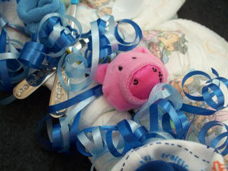 Attach wrist rattles to the diaper wreath