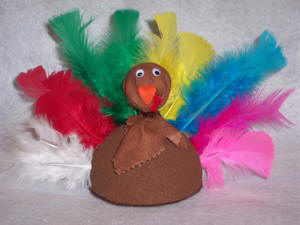 Craft a Turkey decoration for Thanksgiving out of Styrofoam and feathers.